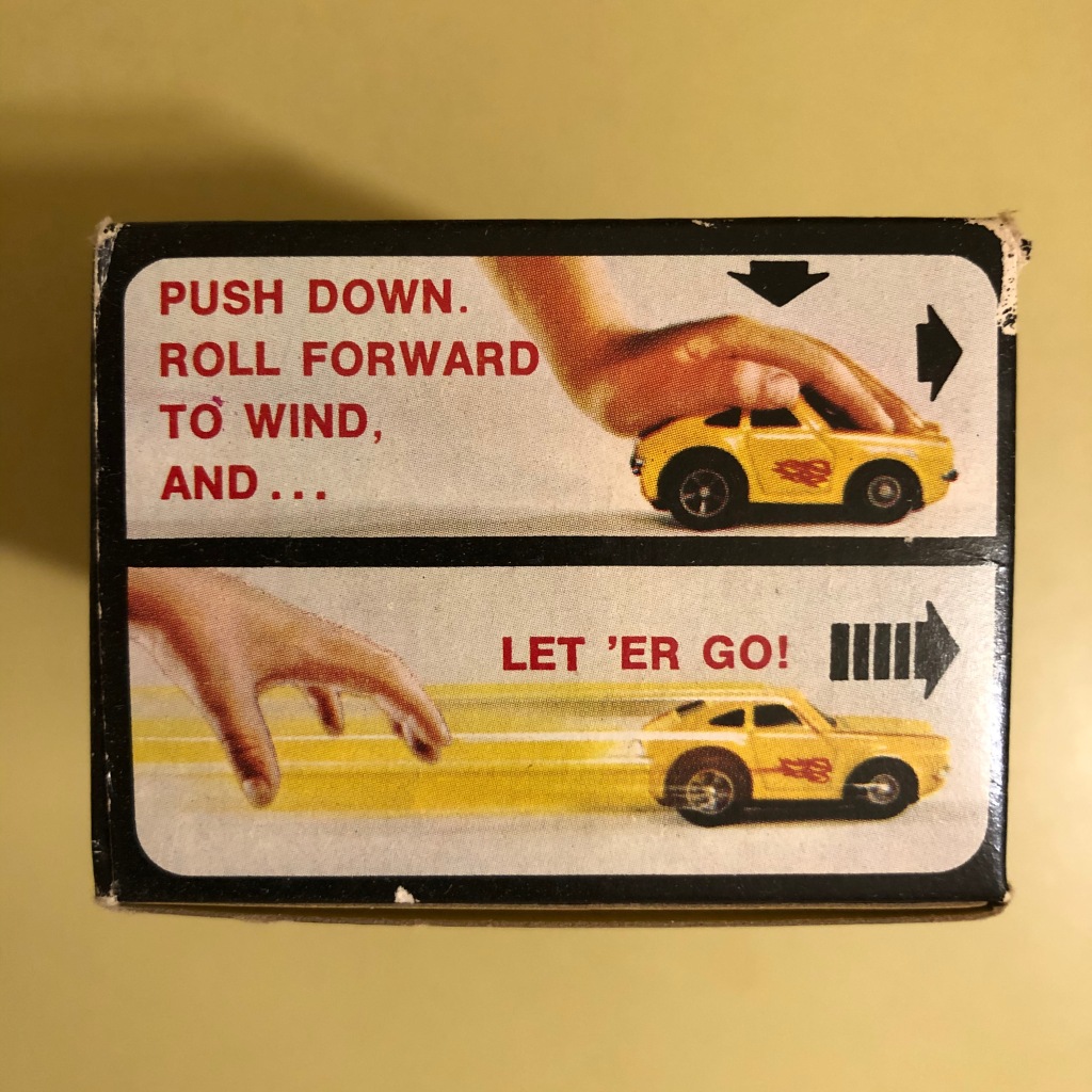 The Tonka Scramblers display box shows how to wind the spring that powers the car: "Push down. roll forward to wind, and ... Let 'er go!"
